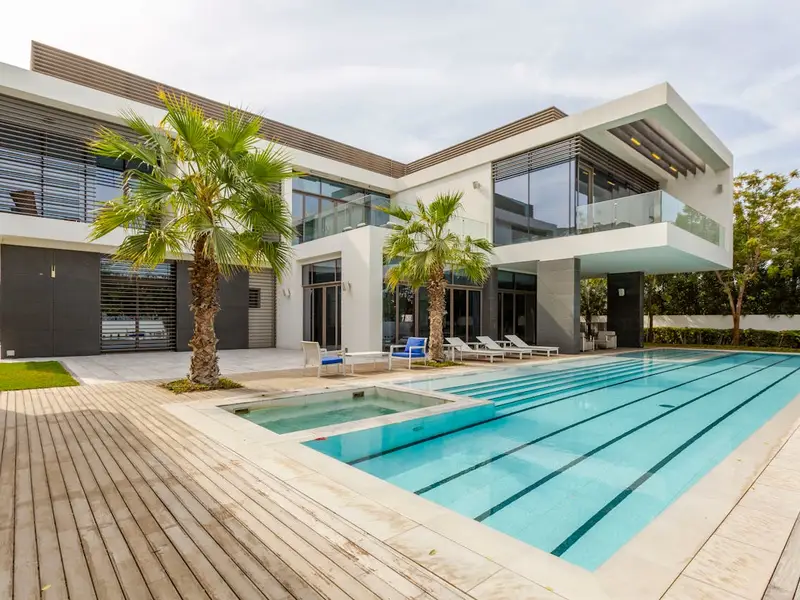 Modern villa with swimming pool at sunset